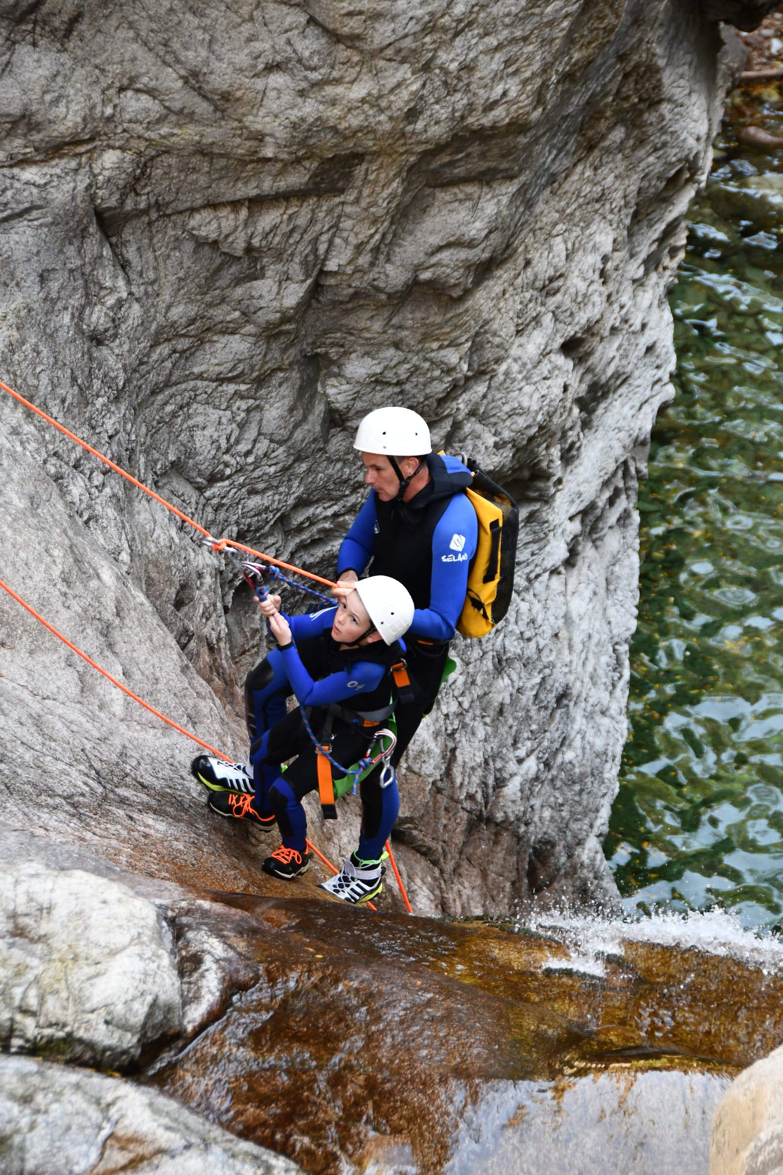 Two people rappelling during our multi-activity holiday