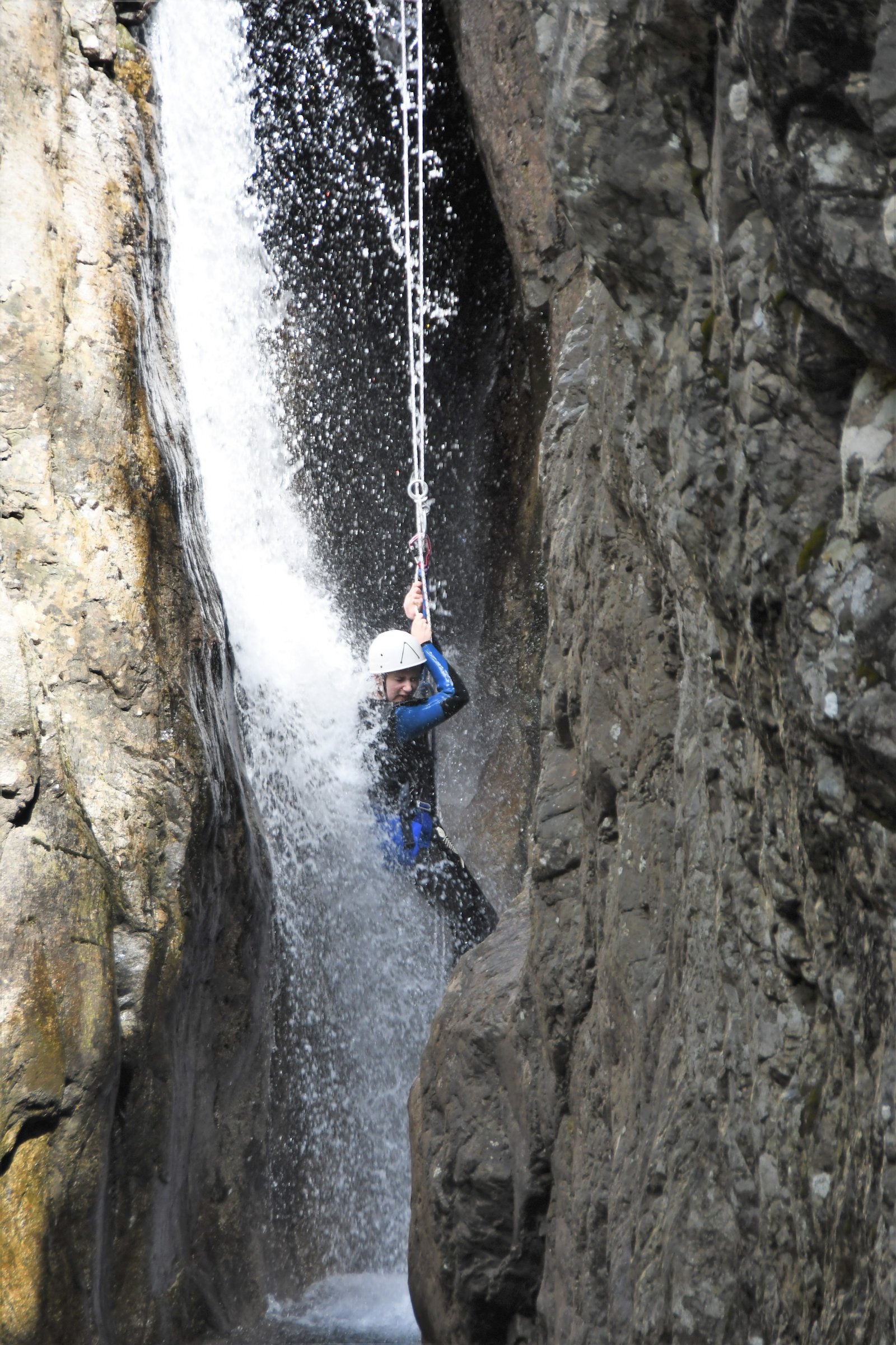 Person rappelling down the waterfall in the Zoicu Canyon