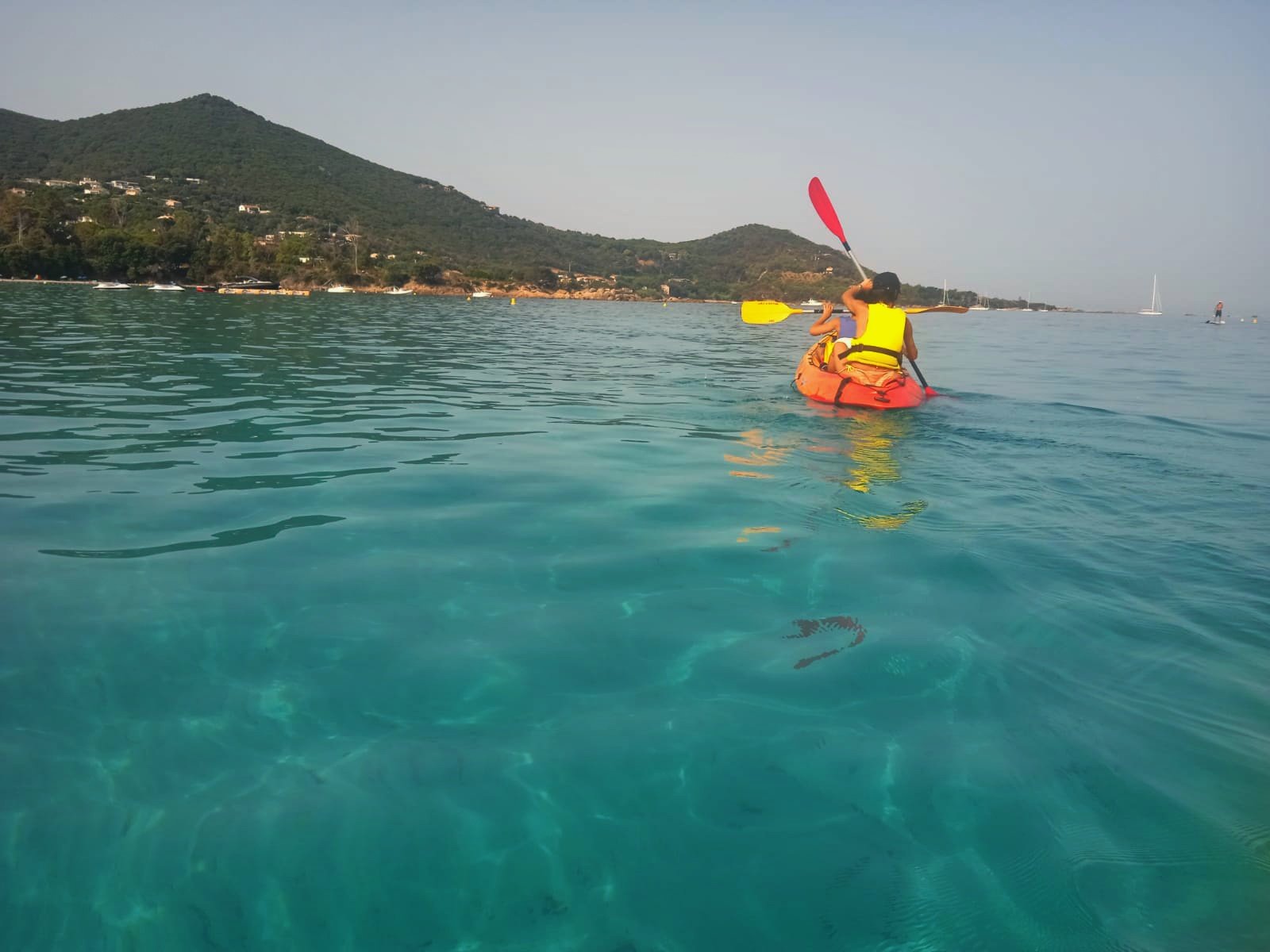 Two people on a two-person kayak on the Mare e Sole beach