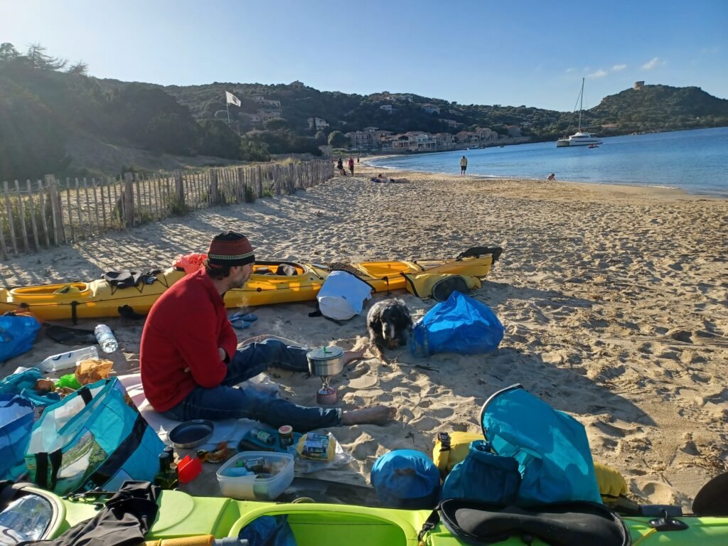 Pat resting on its night camp after a day sea kayaking in Corsica