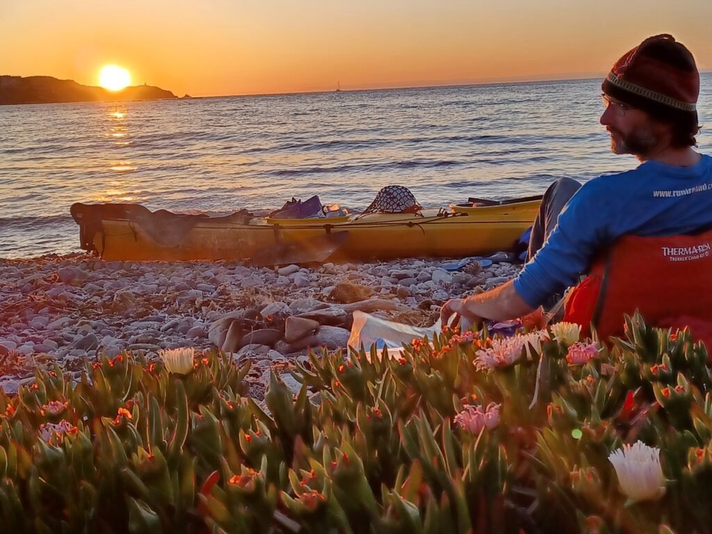 Pat resting on the night camp while admiring a sunset