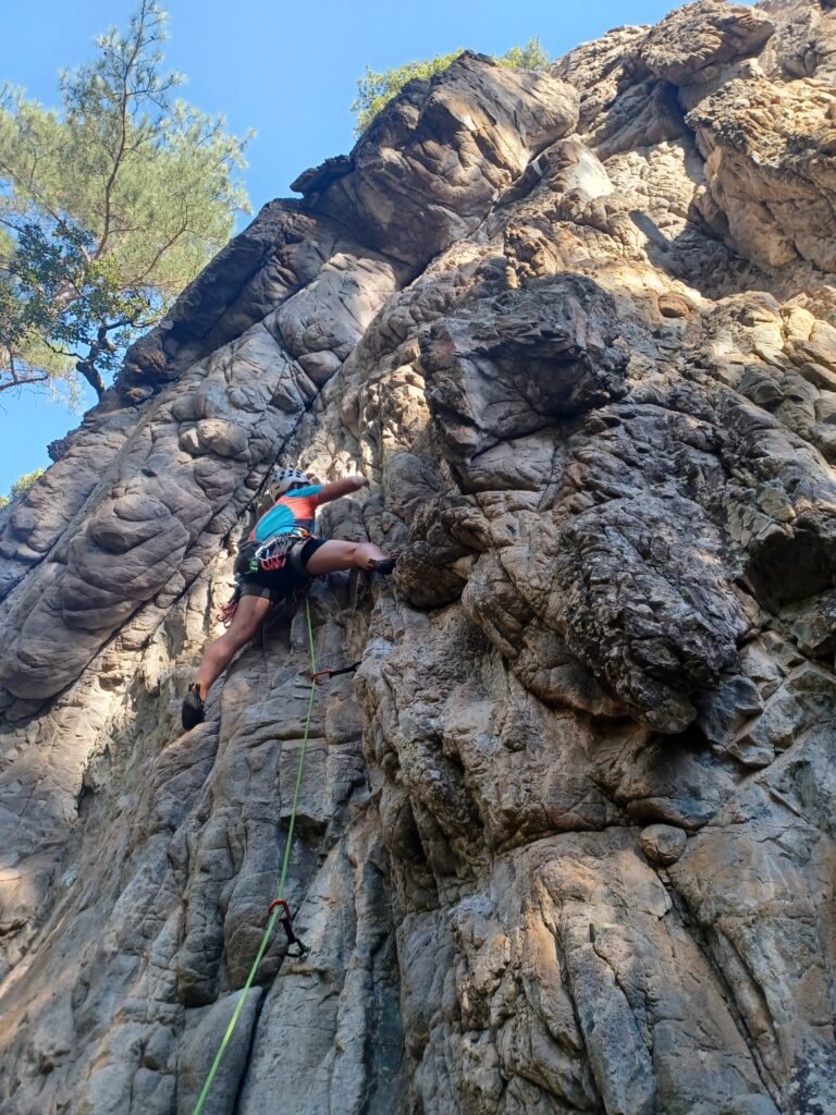 A guy climbing near Ajaccio, one of the sport activities we suggest in Ajaccio