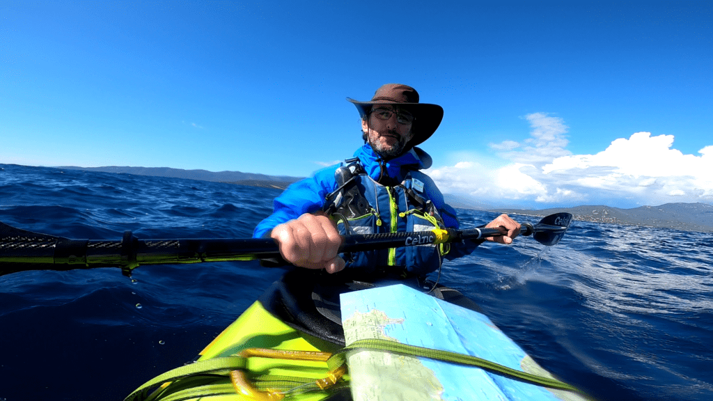 Pat sailing around a sea kayak in Corsica