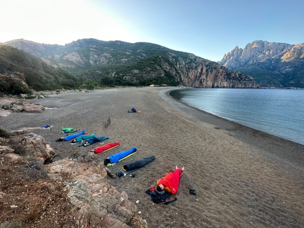 People sleeping on the beach in Corsica following the current regulations